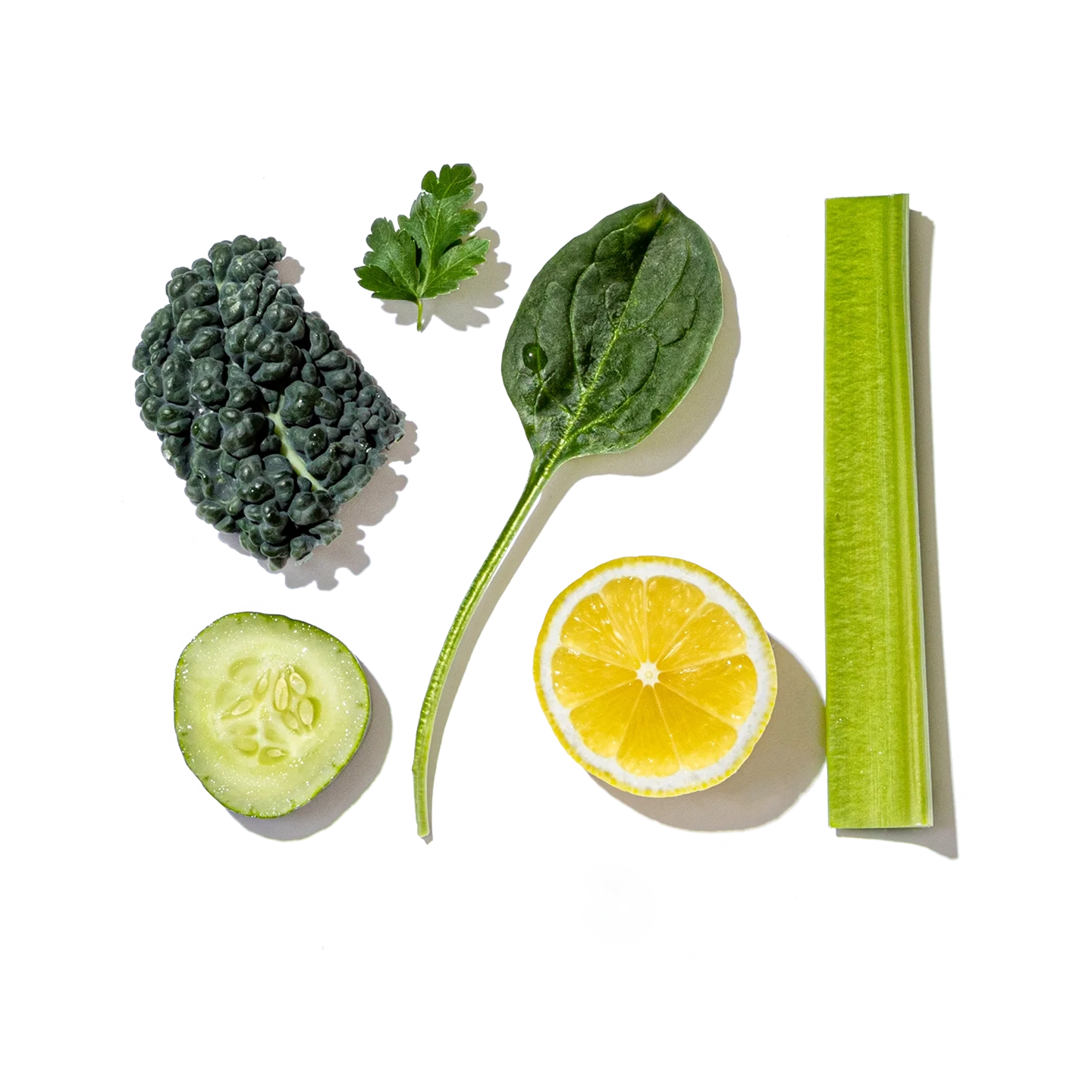 Collection of green vegetables and a lemon on a white background