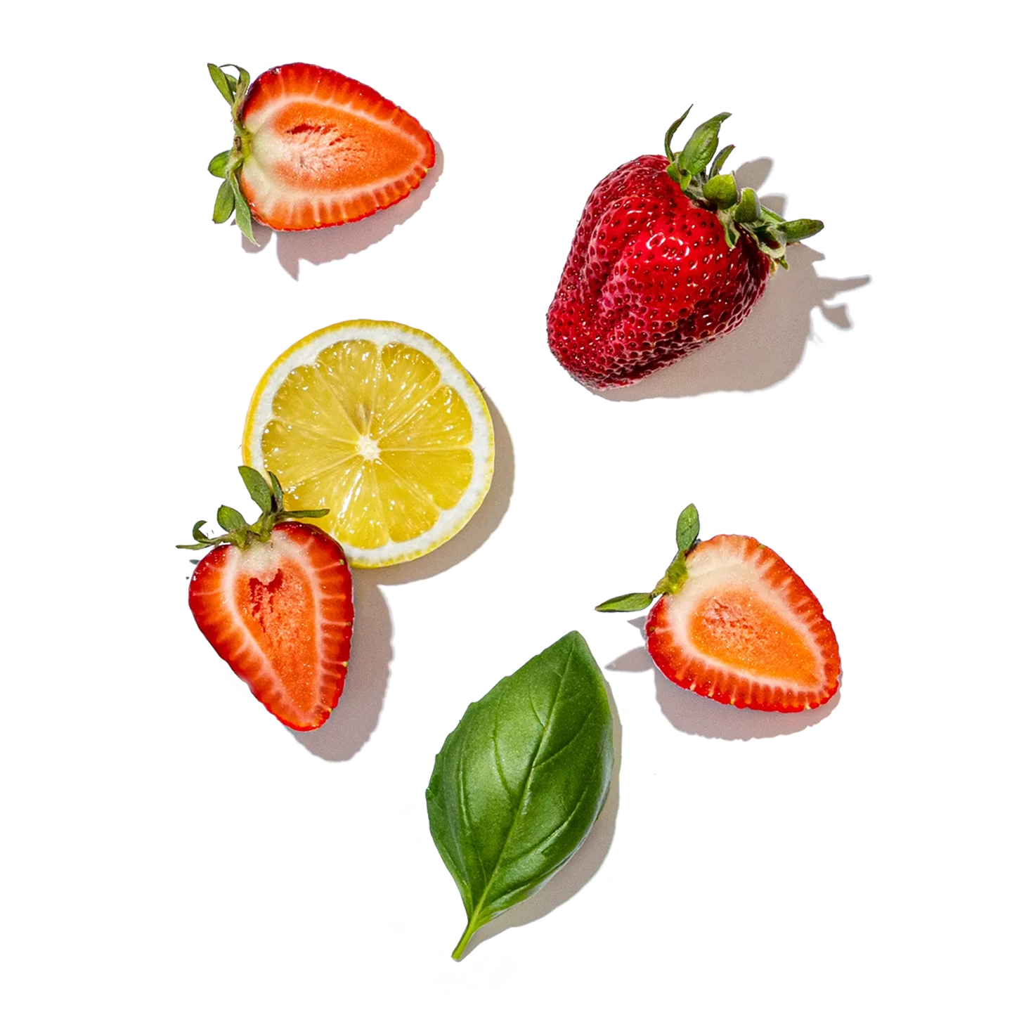 Strawberries, lemon, and basil leaf on a transparent background