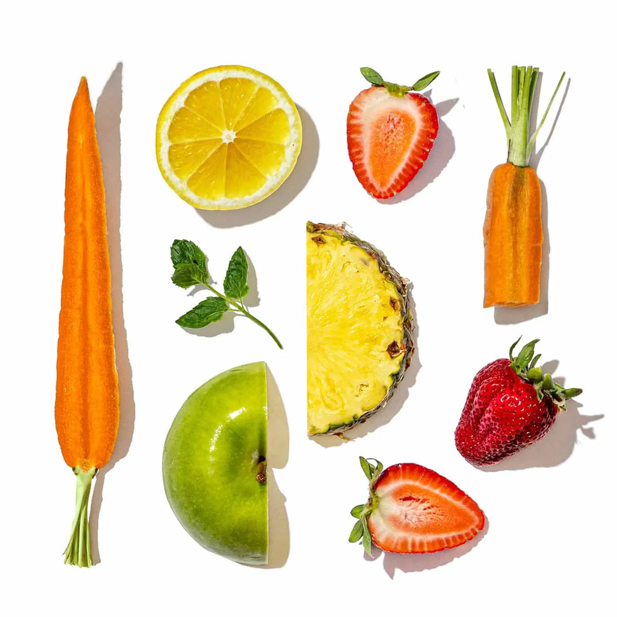 Fruits and vegetables arranged in a grid on a white background