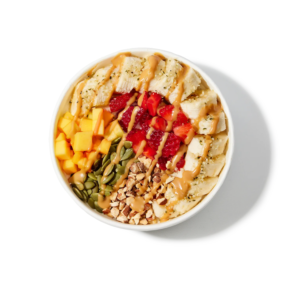 White bowl filled with a colorful mix of fruits, nuts, and seeds on a white background