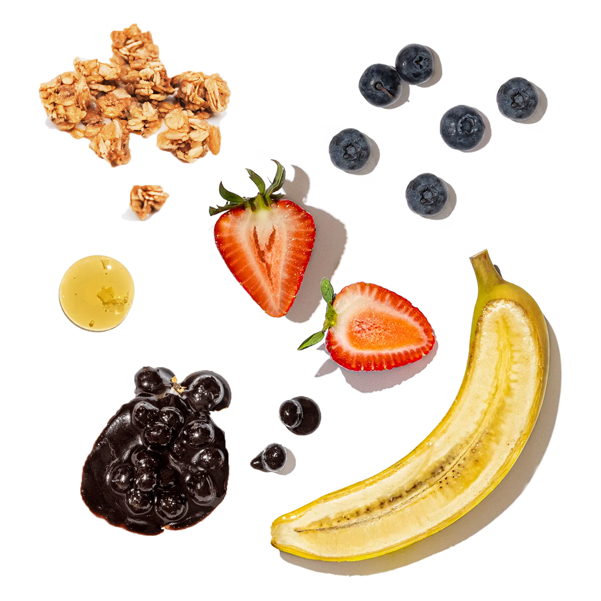 Fruit and granola arrangement on a white background