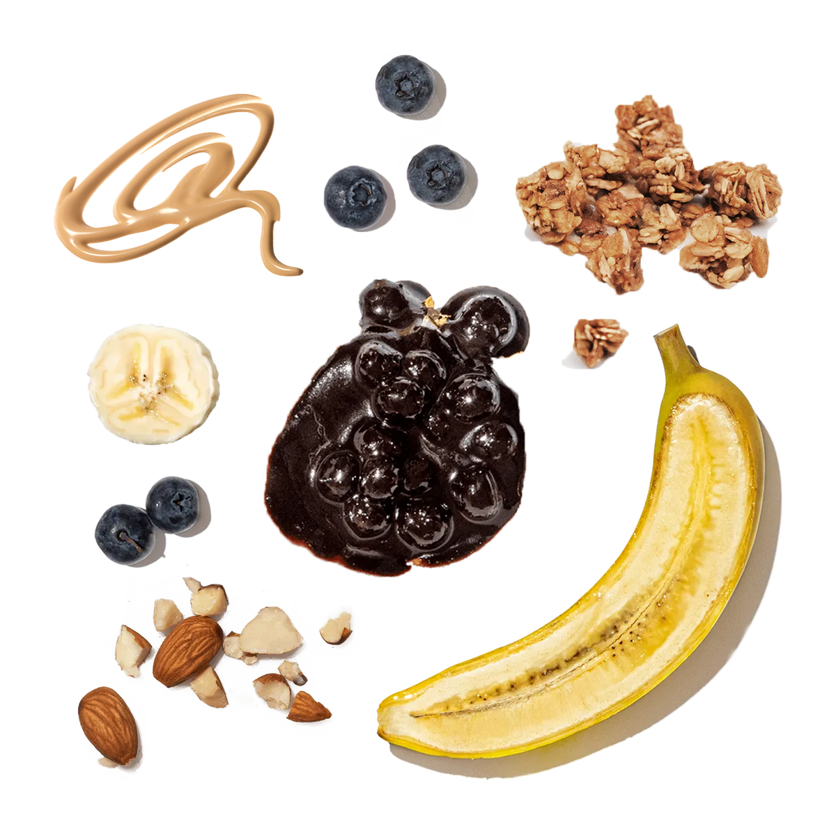 Ingredients for a snack including peanut butter, blueberries, granola, banana, and nuts on a white background.
