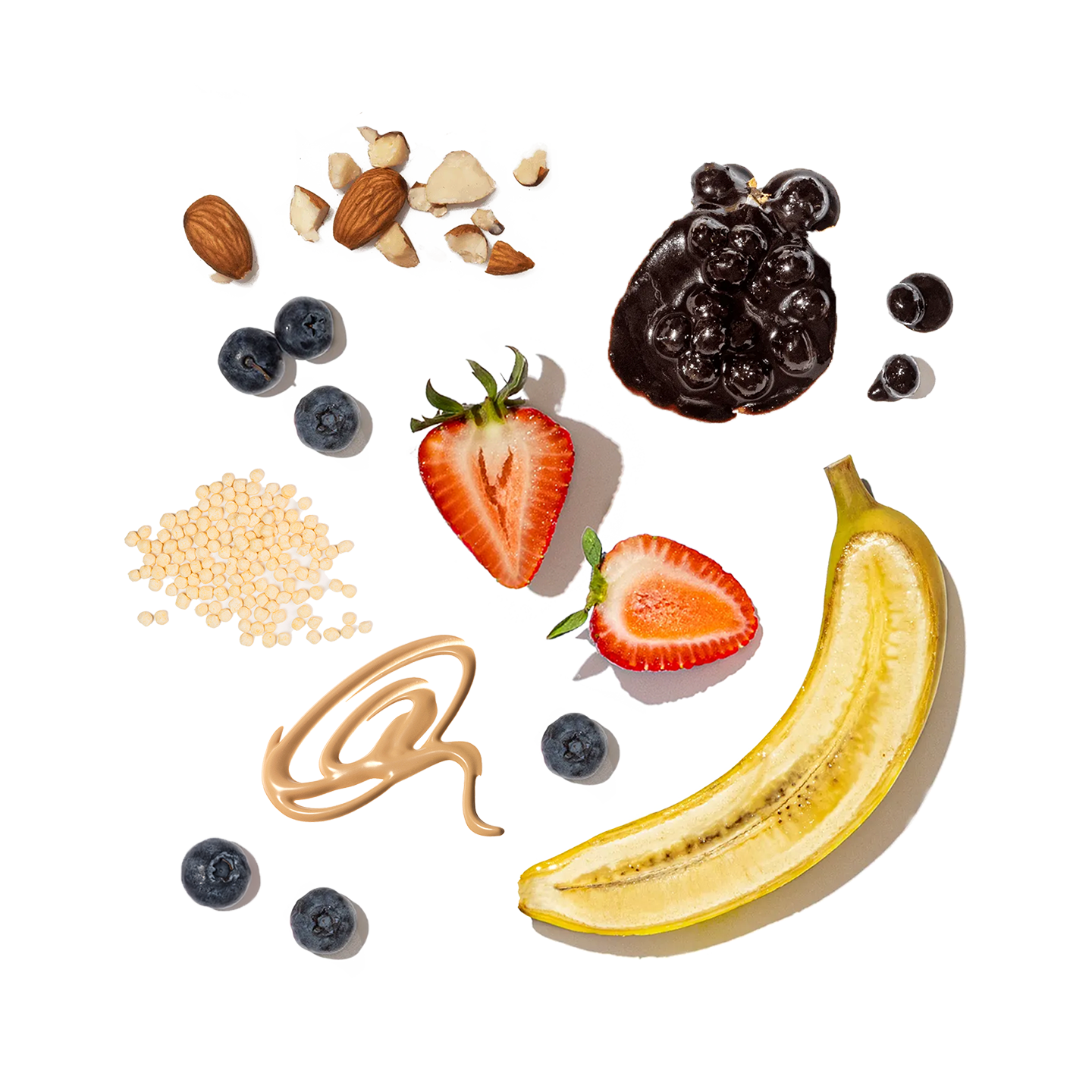Fruits, nuts, and a banana arranged on a white background