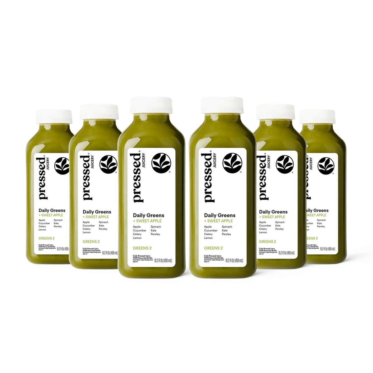 Bottles of 'pressed' Daily Greens juice on a white background