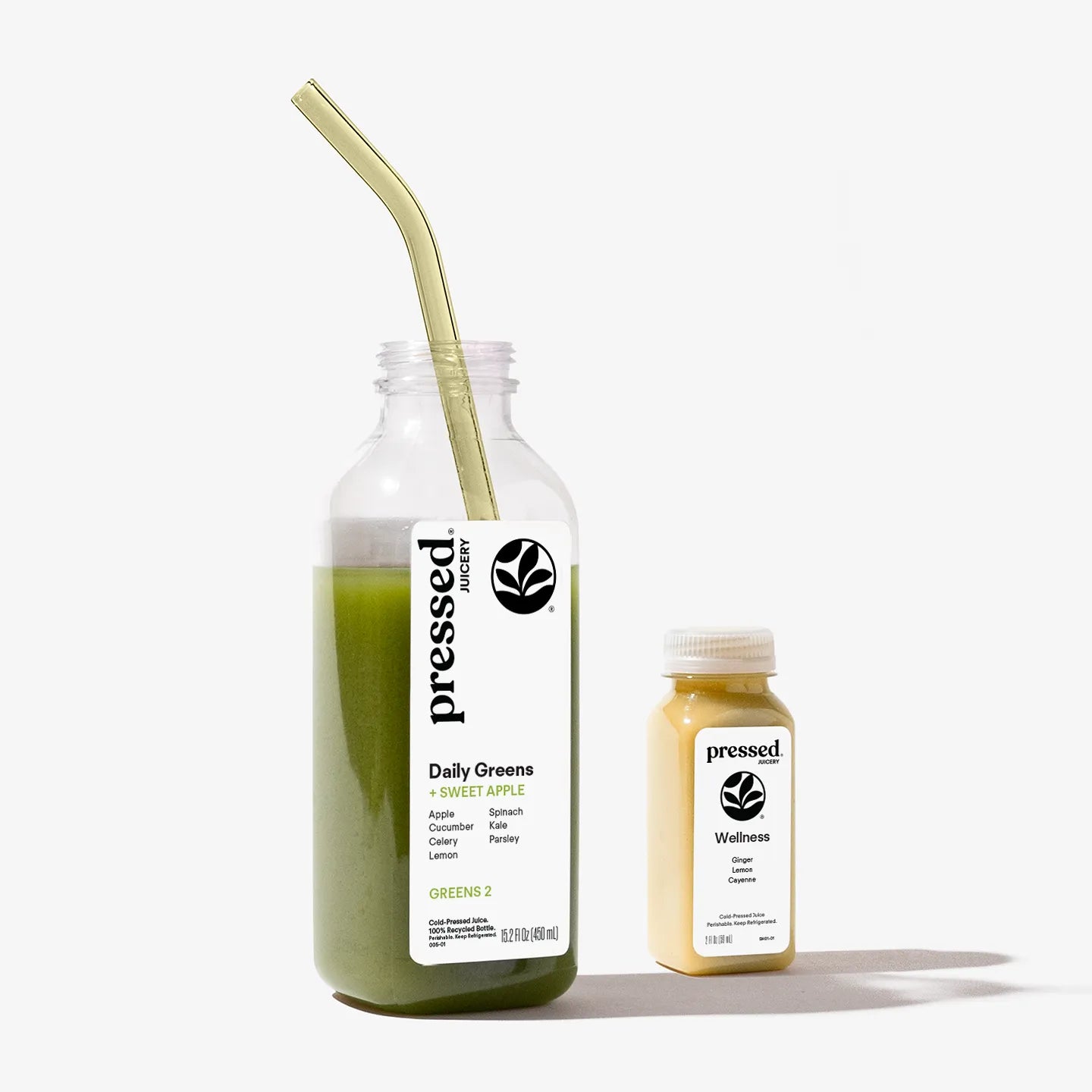 Two bottles of 'pressed' juice with a straw on a white background