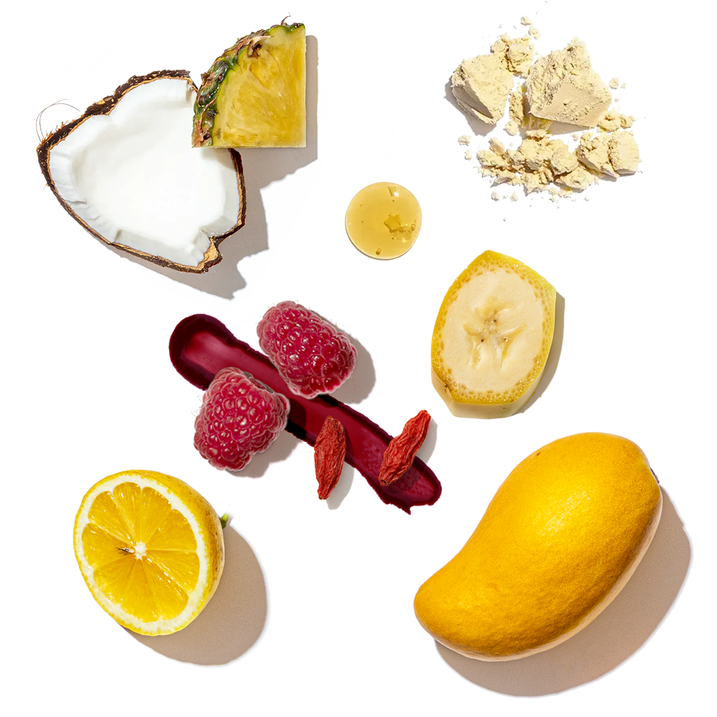Assorted fruits and a bowl of yellow powder on a white background