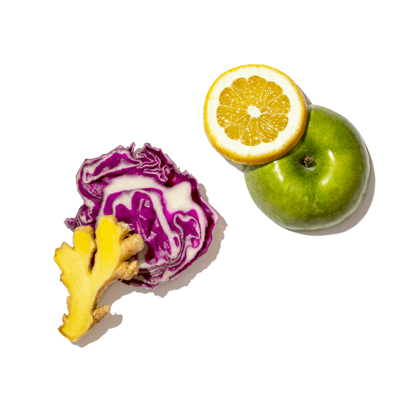 Sliced purple cabbage, orange, and green apple on a white background