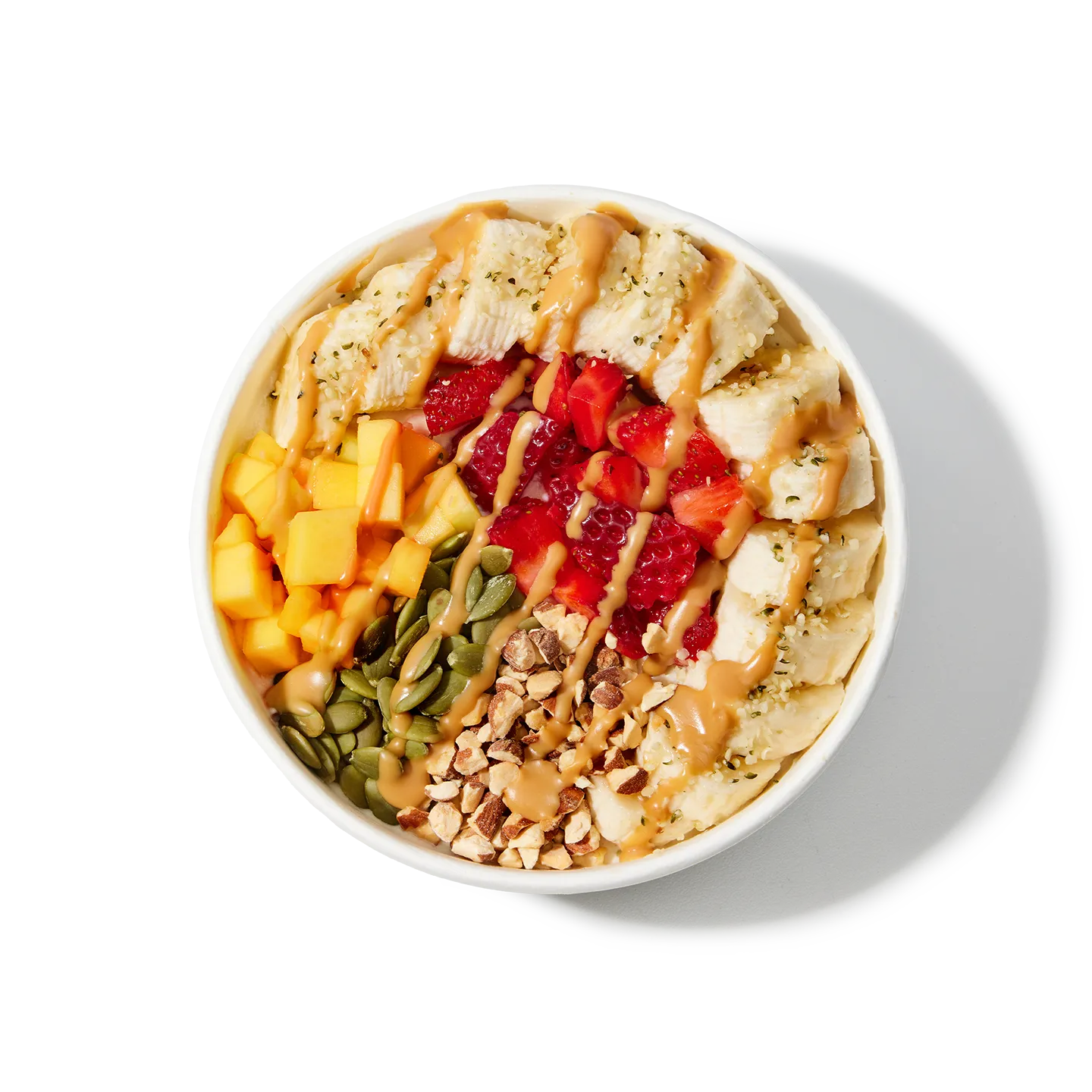 White bowl filled with a colorful mix of fruits, nuts, and seeds on a white background
