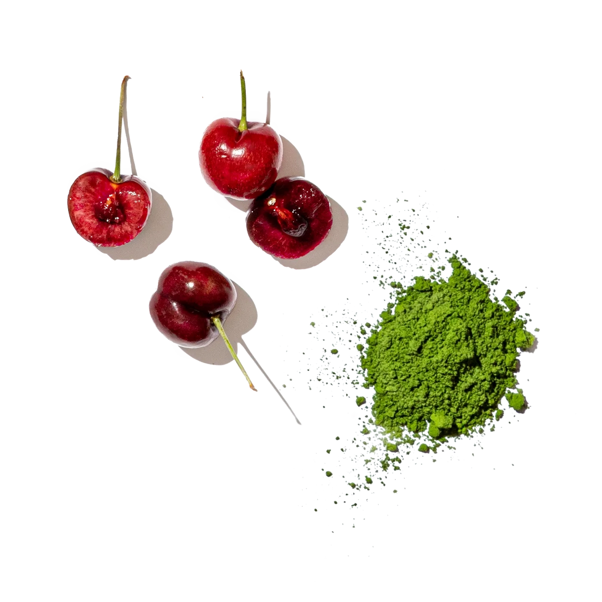 Cherries on a white background with a green leaf and small white flowers.