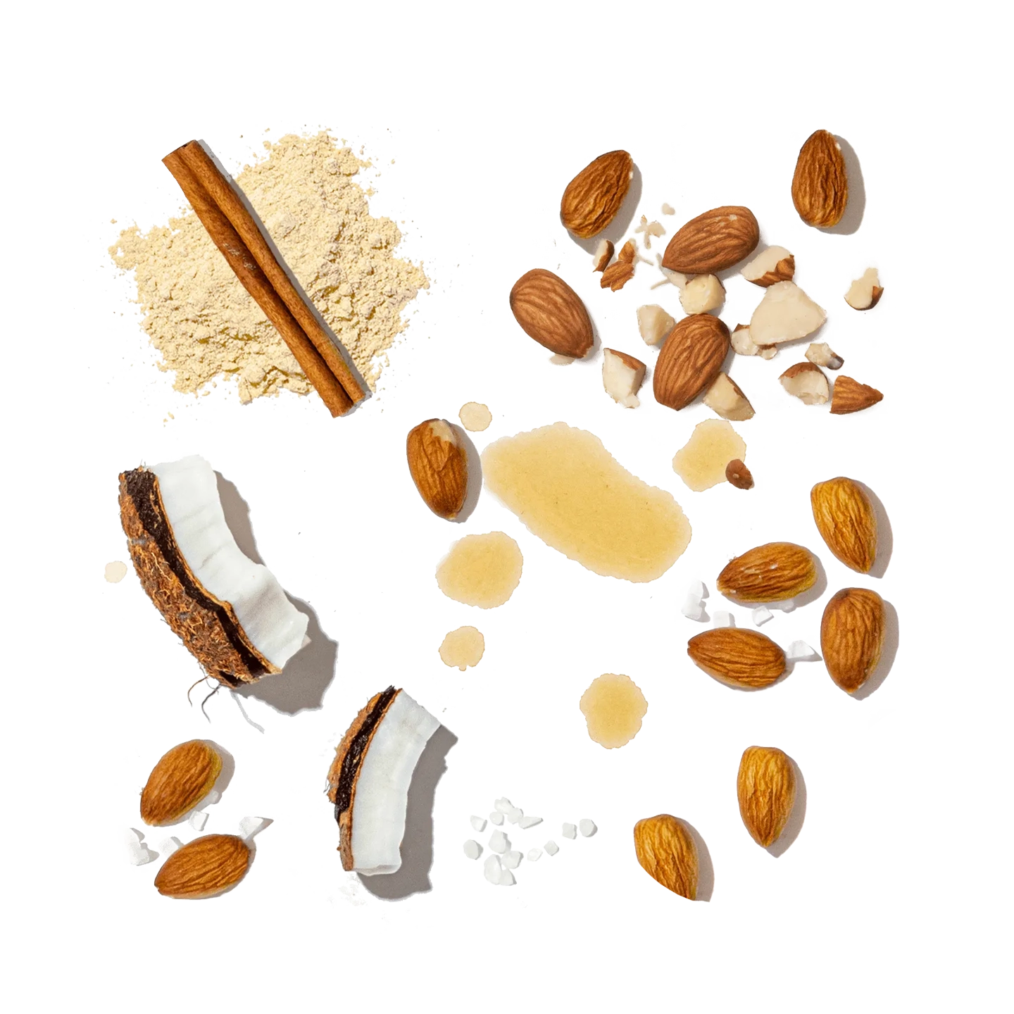 Collection of various nuts, seeds, and a cinnamon stick on a white background