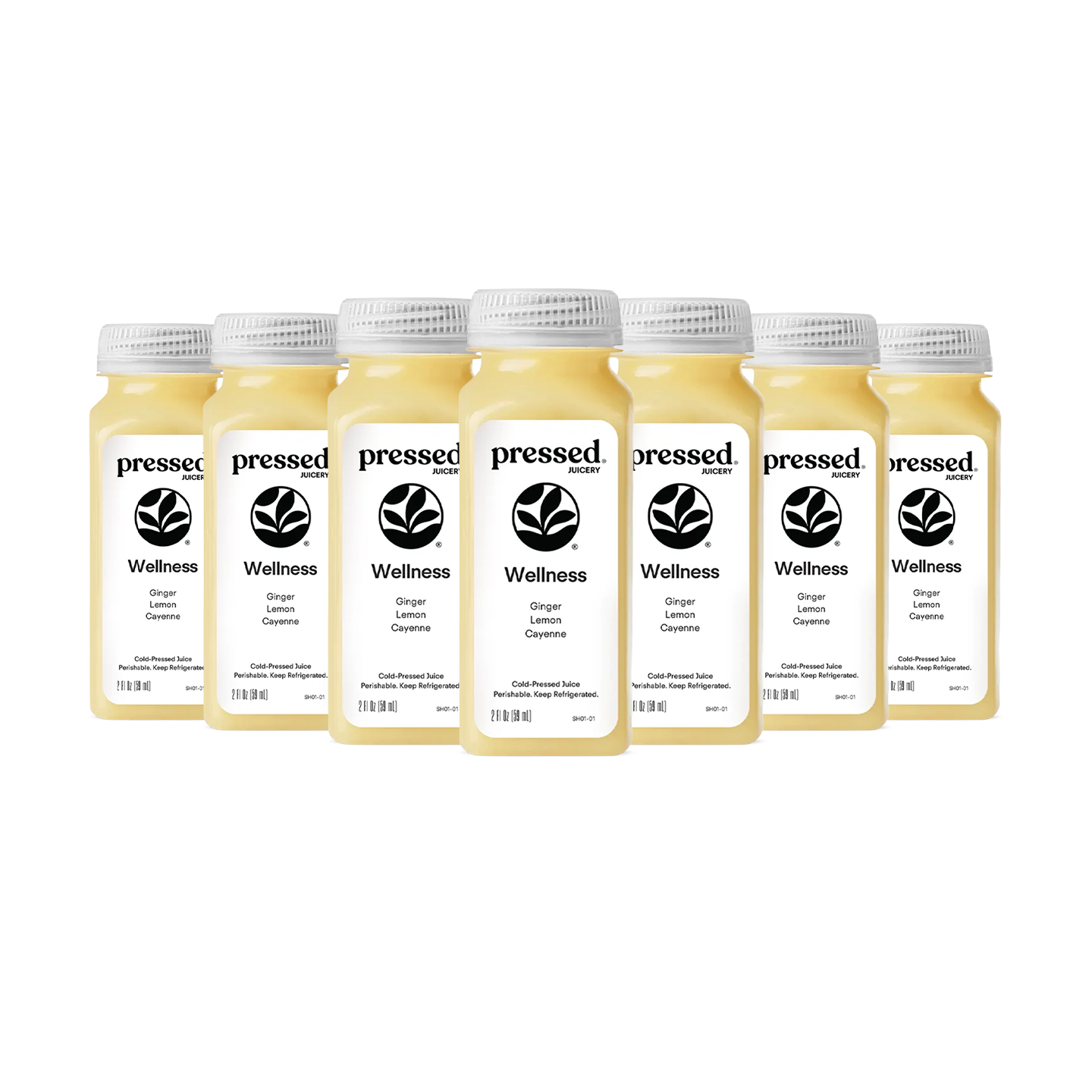 Six small plastic bottles of Pressed Wellness 'Wellness' ginger lemonade syrup arranged in a row on a plain white background.