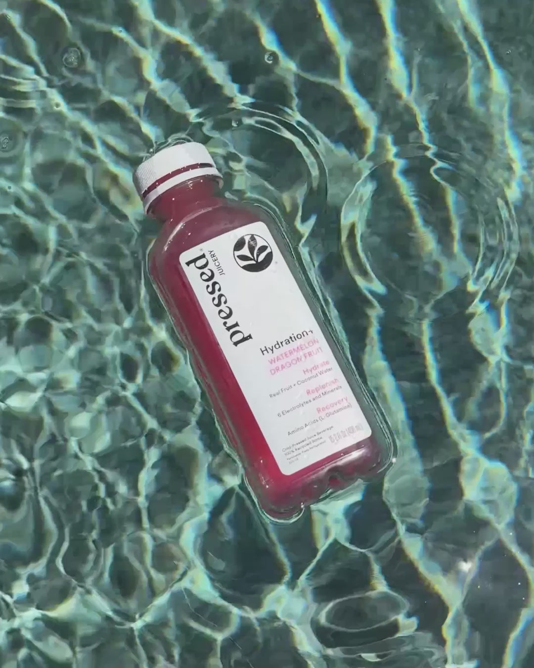 Video of the Hydration+ Watermelon Dragon Fruit floating in a pool then being sipped poolside, folllowed by a poolside plate of watermelon, lime, and bottles of the juice.