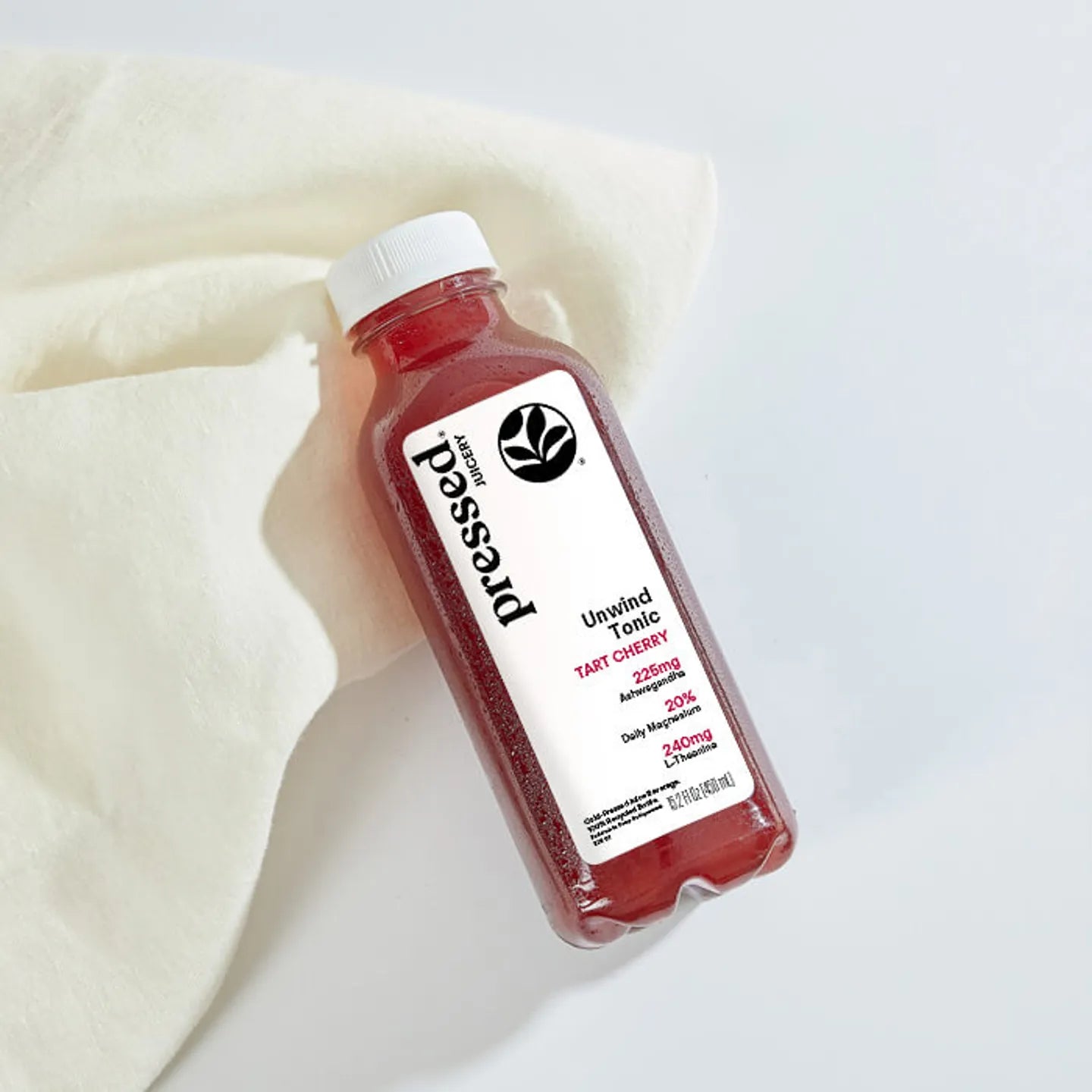 Bottle of 'possed' tart cherry juice on a light background
